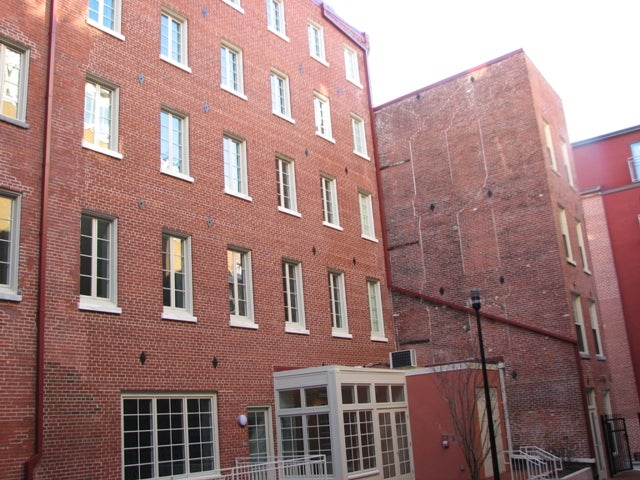 Rear view of the buildings, where collapsing floors could be seen through walls two years ago.