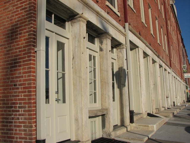 The Early Republic architecture of the Girard Warehouses has been preserved in the street-level entrances on Front Street.