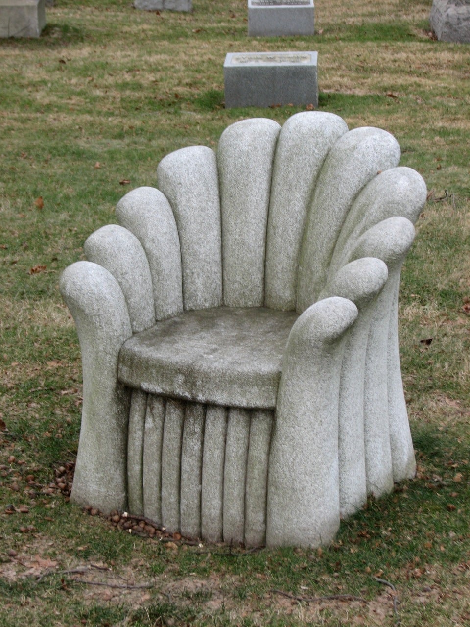 A pair of stone chairs in the Art Nouveau style provided a place for mourners to rest at one family vault.