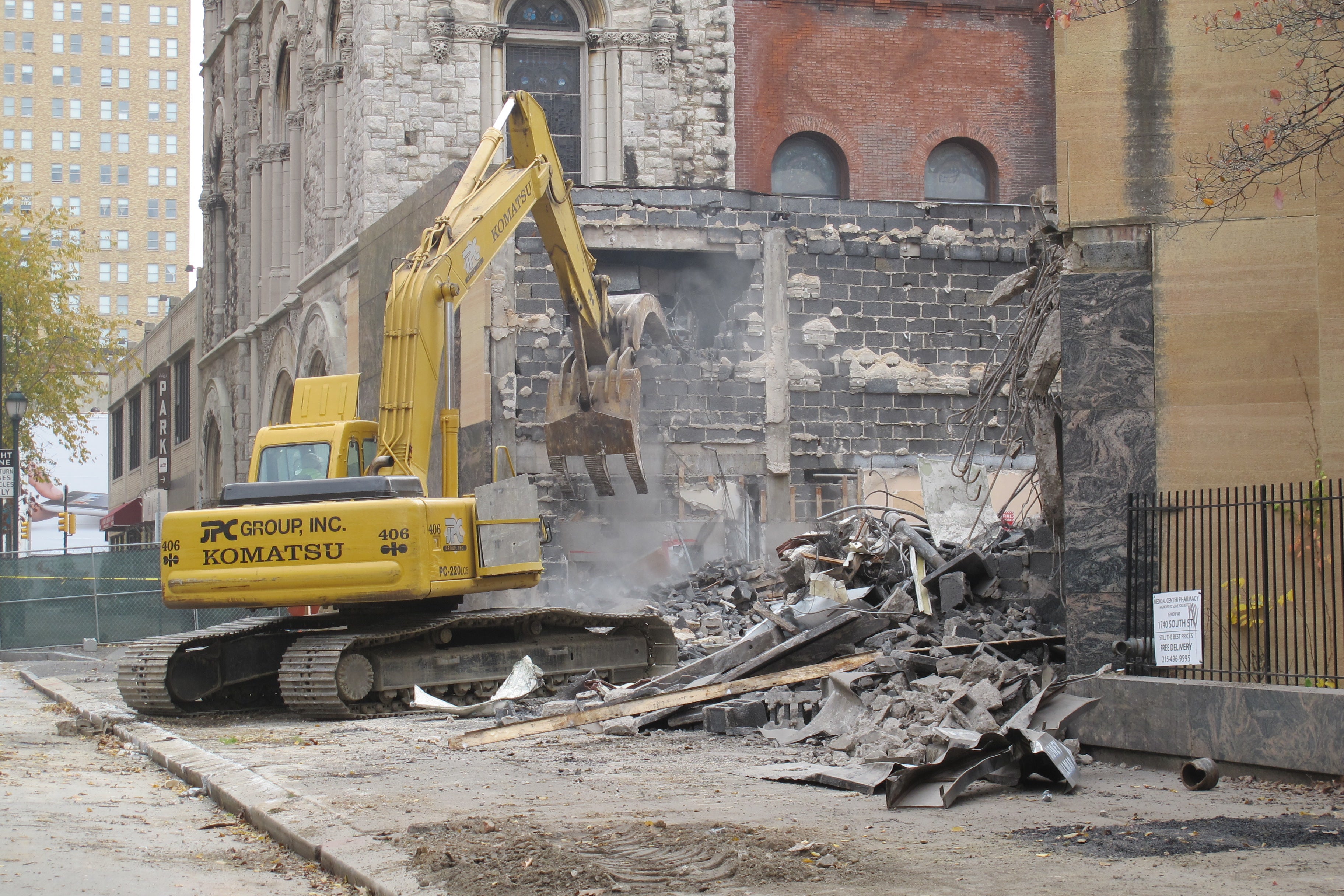 As mitigation for the loss, developers John Buck Co. are supporting preservation projects, including one at the Evangelical Lutheran Church next door (seen behind bulldozer).