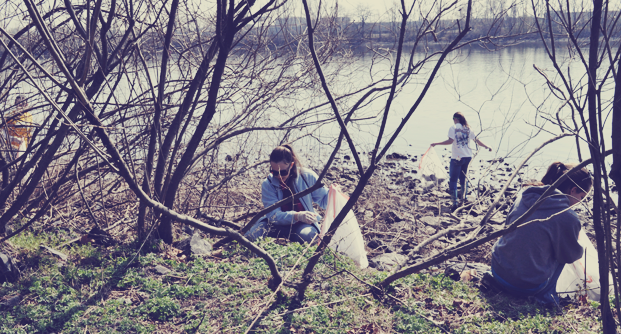 Volunteers clean up trash along the Schuylkill River at Batram's Garden. | United by Blue