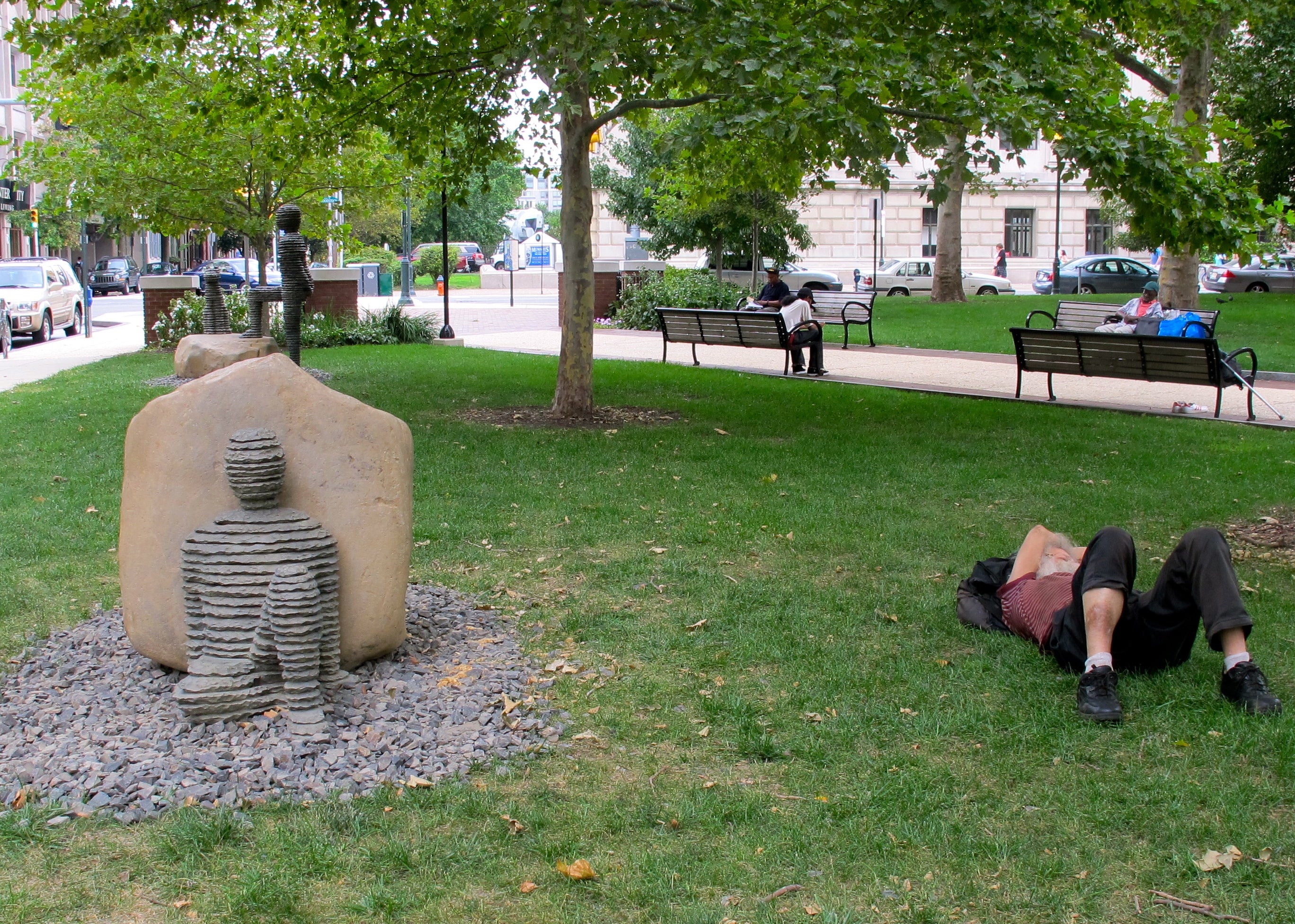 Art imitating life: homeless man sleeps in Aviator Park next to one of the recently installed Boaz Vaadia sculptures.