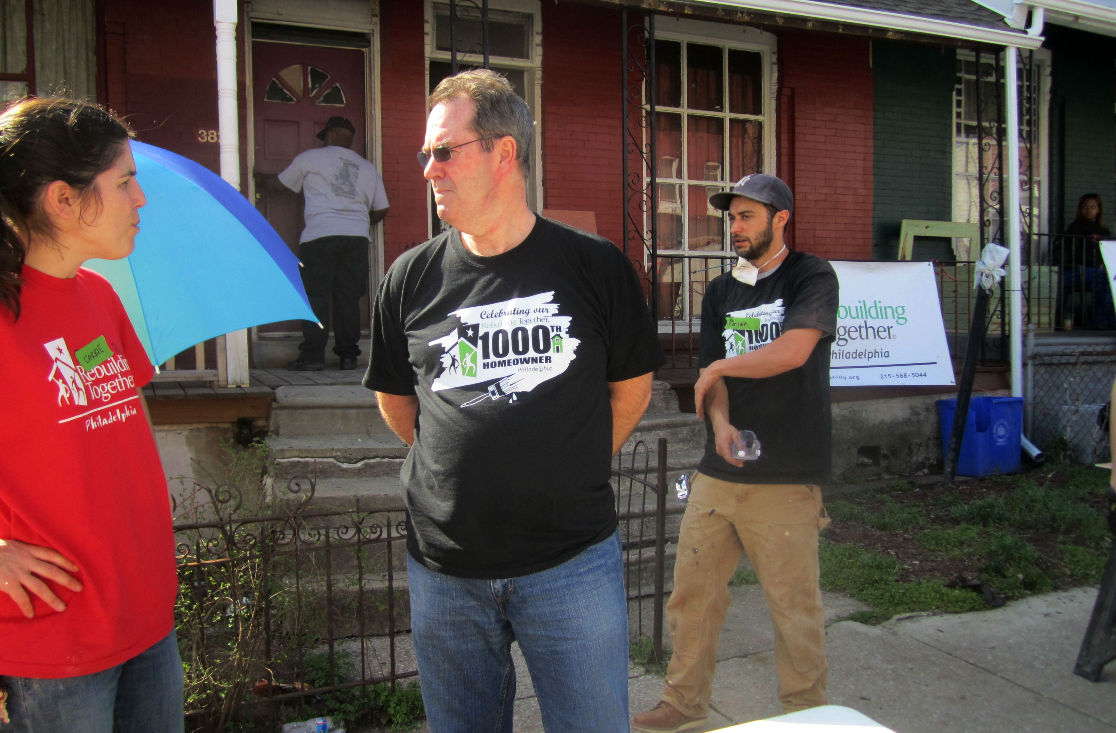 Rebuilding Together Philadelphia Executive Director Carrie Rathmann, right, talks with one of eight volunteers from Choice Hotels. | Christine Fisher