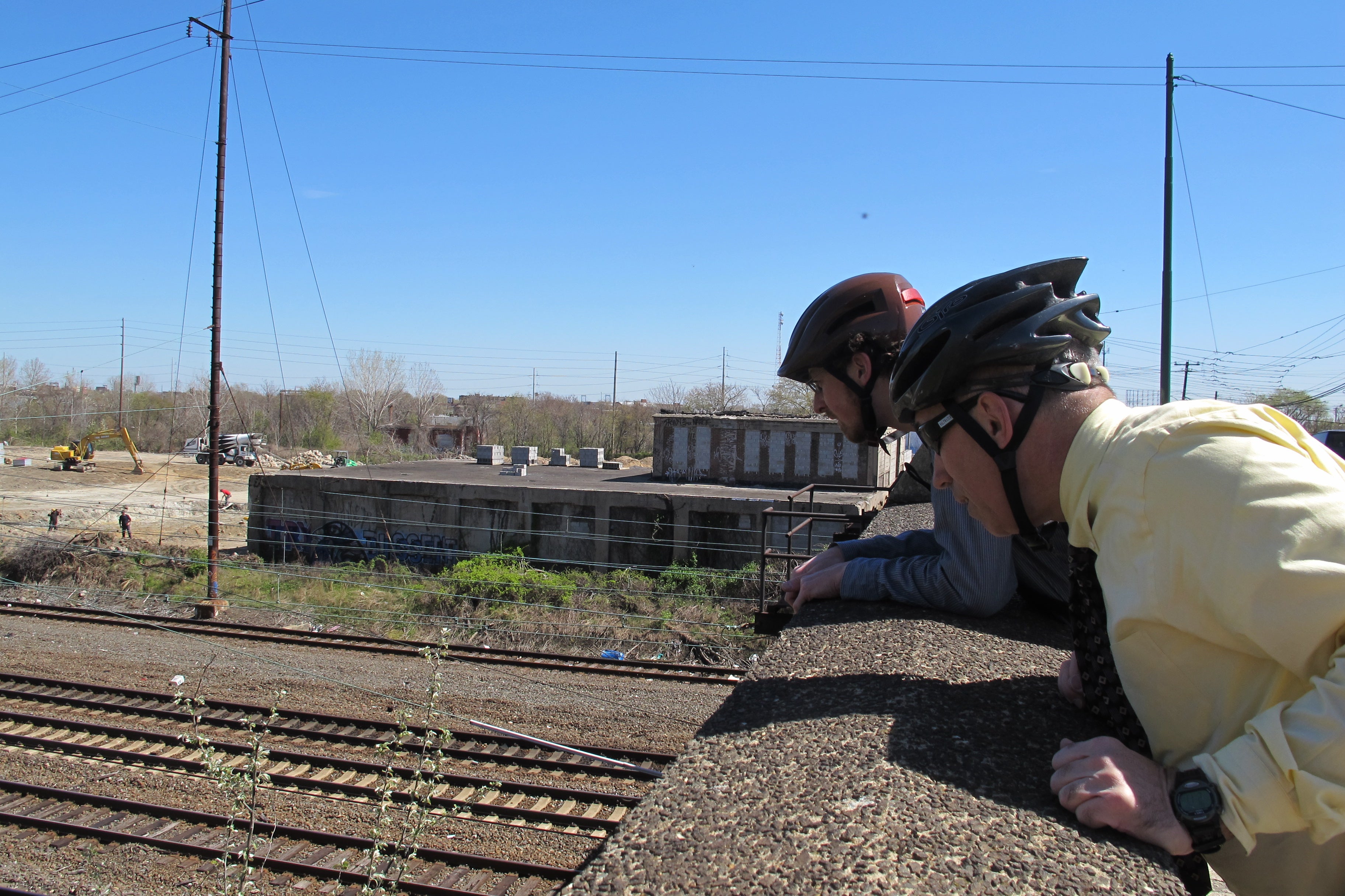 Aaron and Charles peering over a rail bridge on Gray's Avenue.