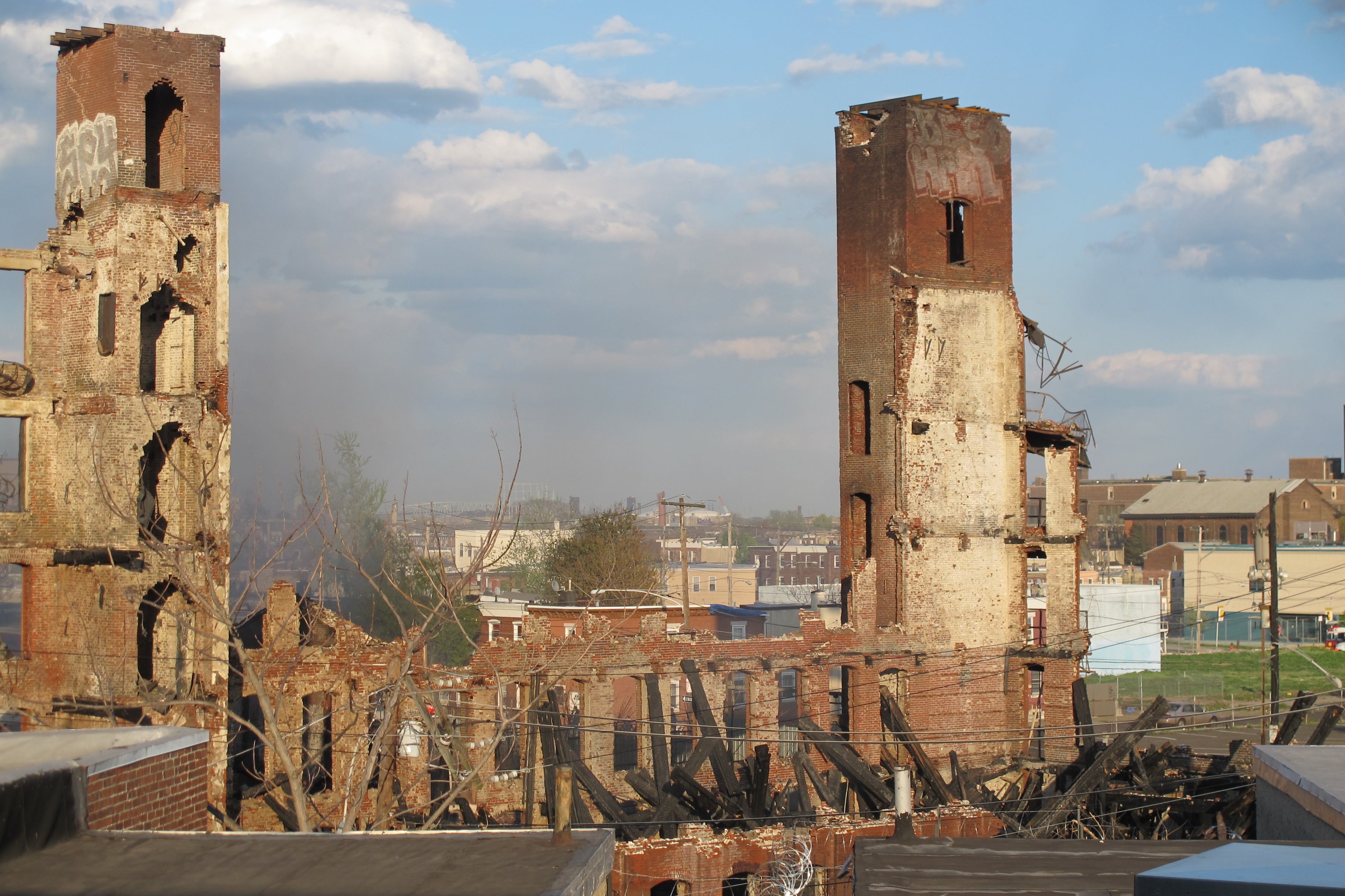 Still smoldering: the remains of Buck Hosiery late Monday afternoon as seen from the El platform.