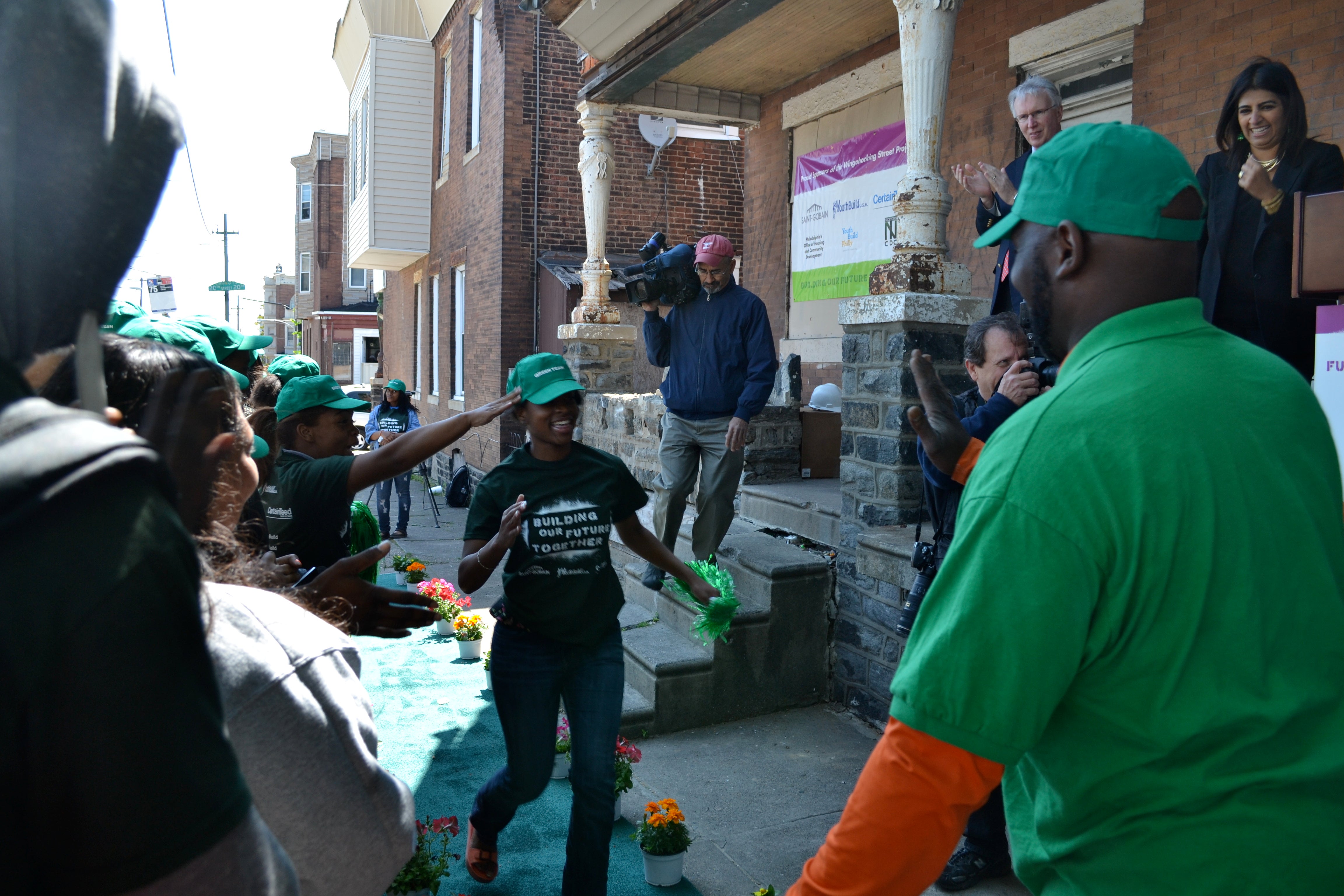 YouthBuild Philadelphia students ran down a green carpet at the groundbreaking 