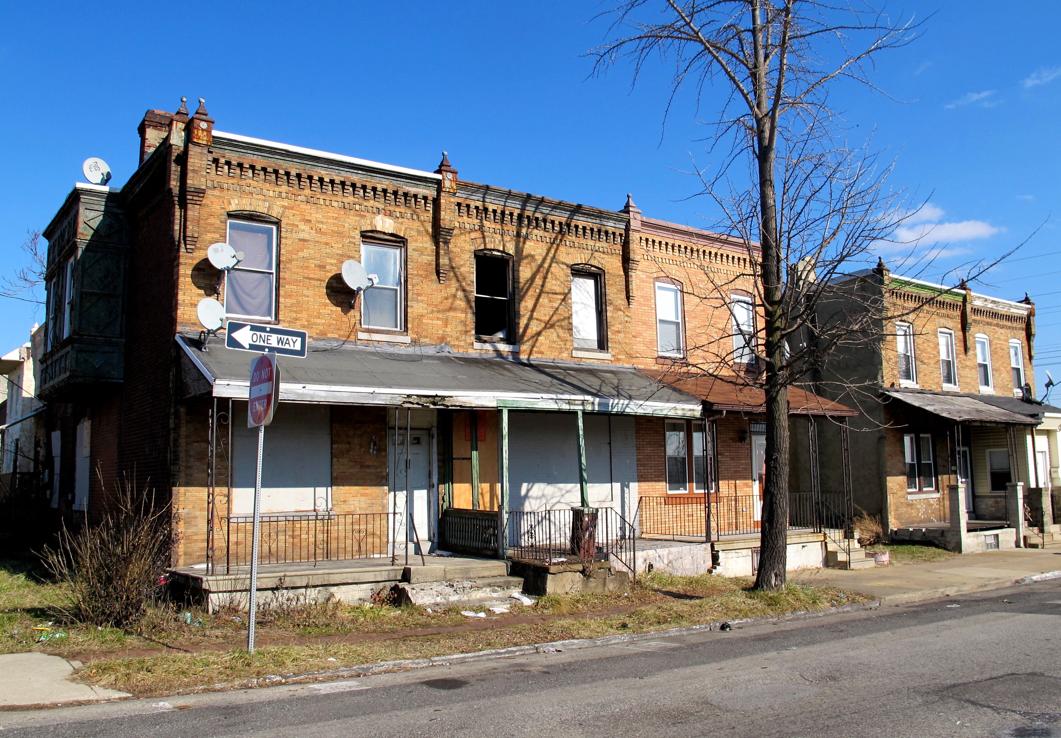 Guy Thigpen's tax delinquent property is the structure with the window missing, orange notice on door