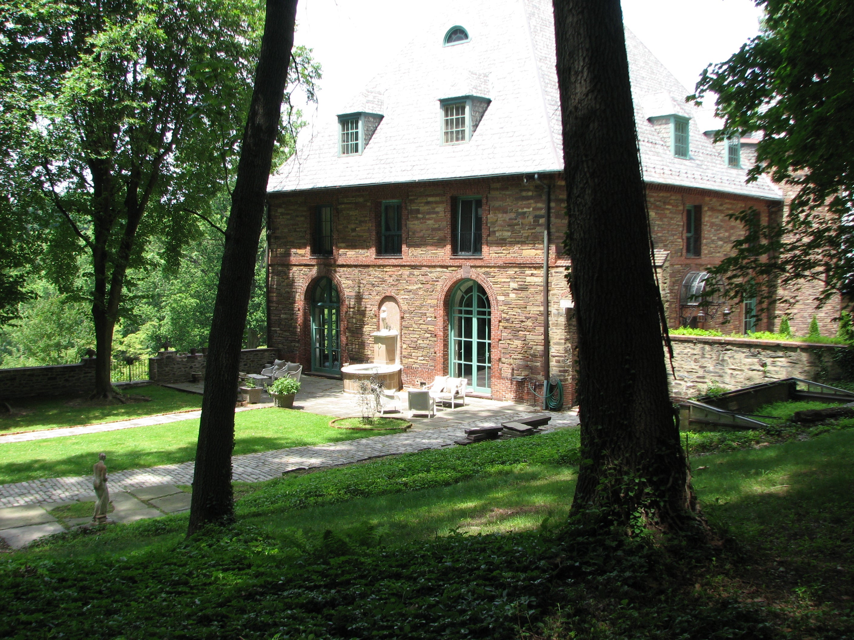 Elegant arched doors open to the outer court of High Hollow.