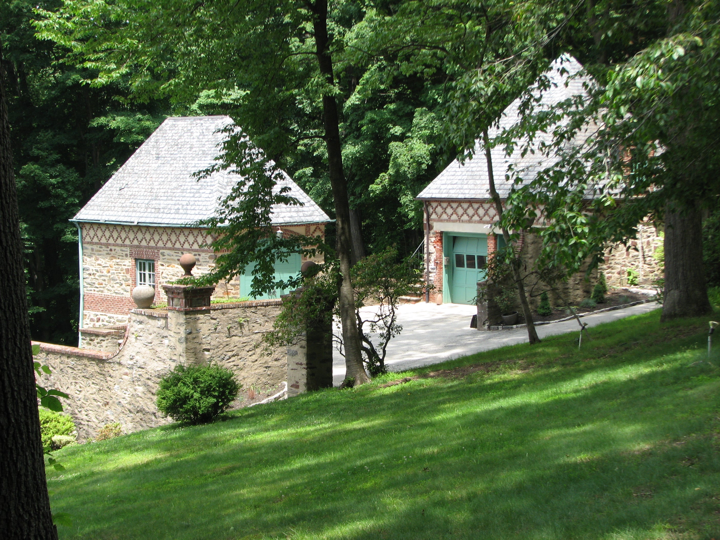 Outbuildings sit on a separate ledge overlooking the park.