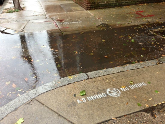 First place winner Lauren Wolf snapped a photo of flooded Locust and Hutchinson streets where graffiti reads “No Diving.” | Photo courtesy of the Clean Air Council.