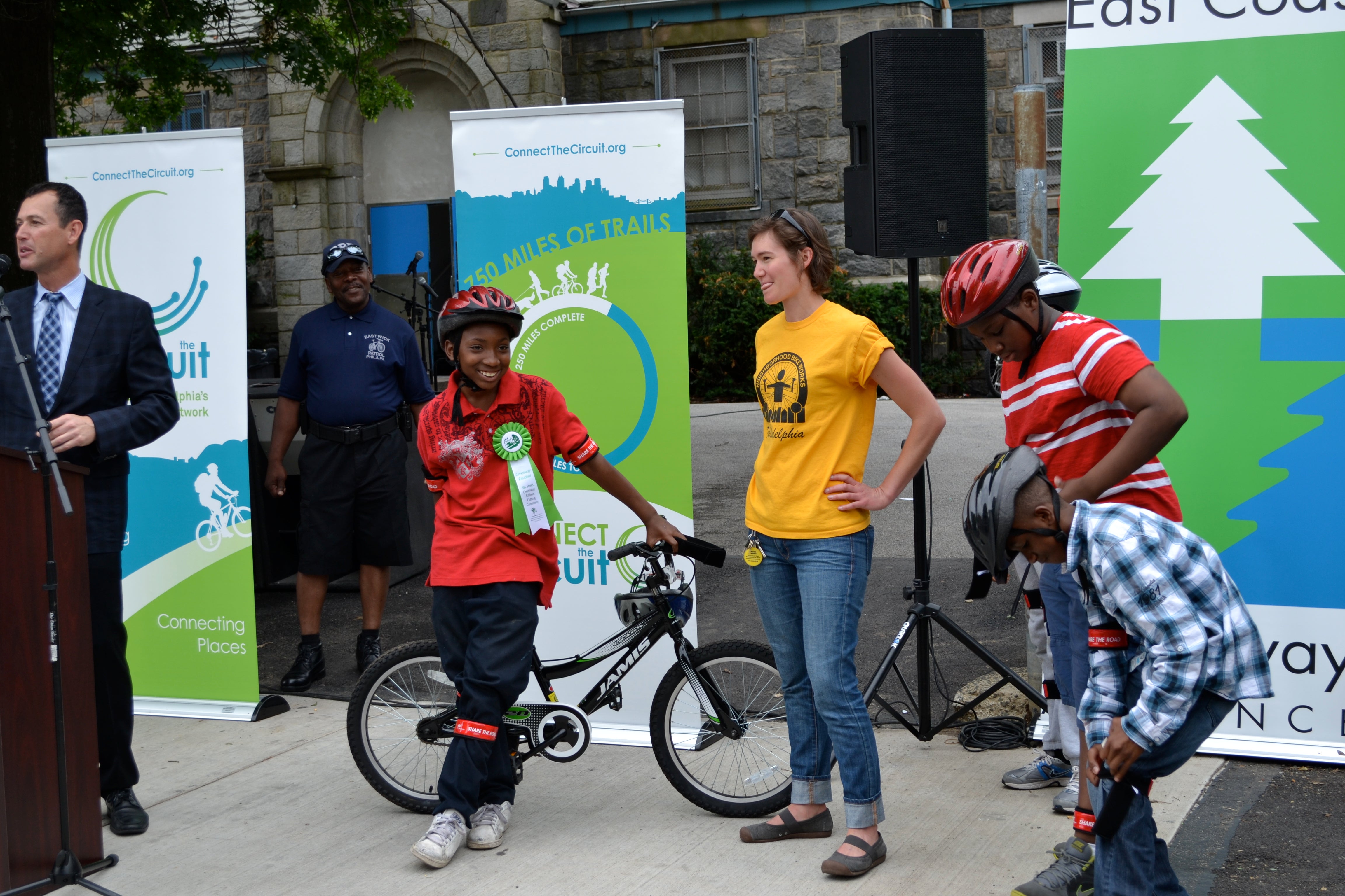 Neighborhood Bike Works raffled off a new bicycle just before the ribbon cutting