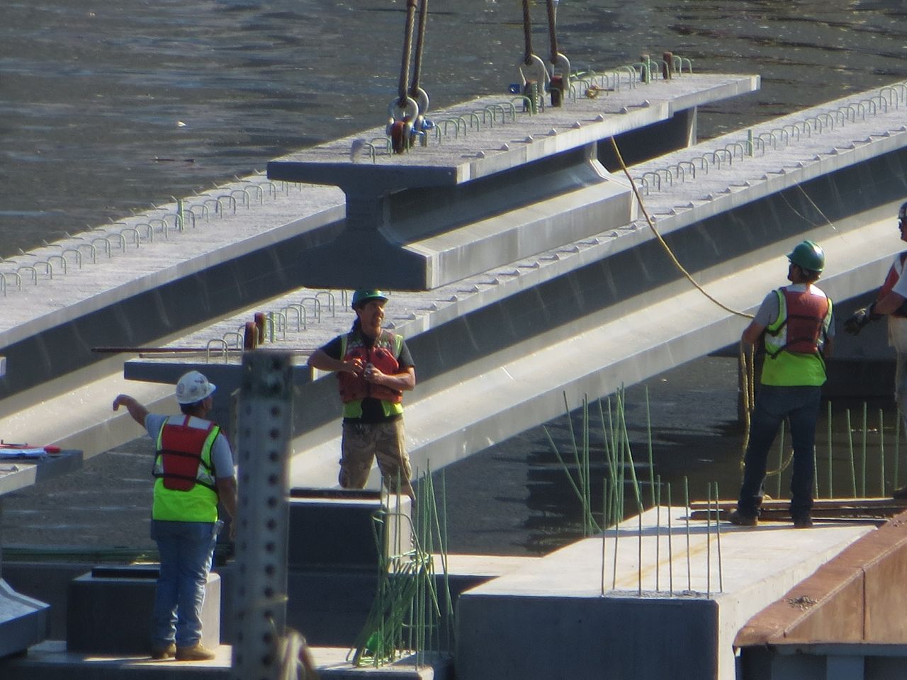 A concrete section of the boardwalk is lowered into place
