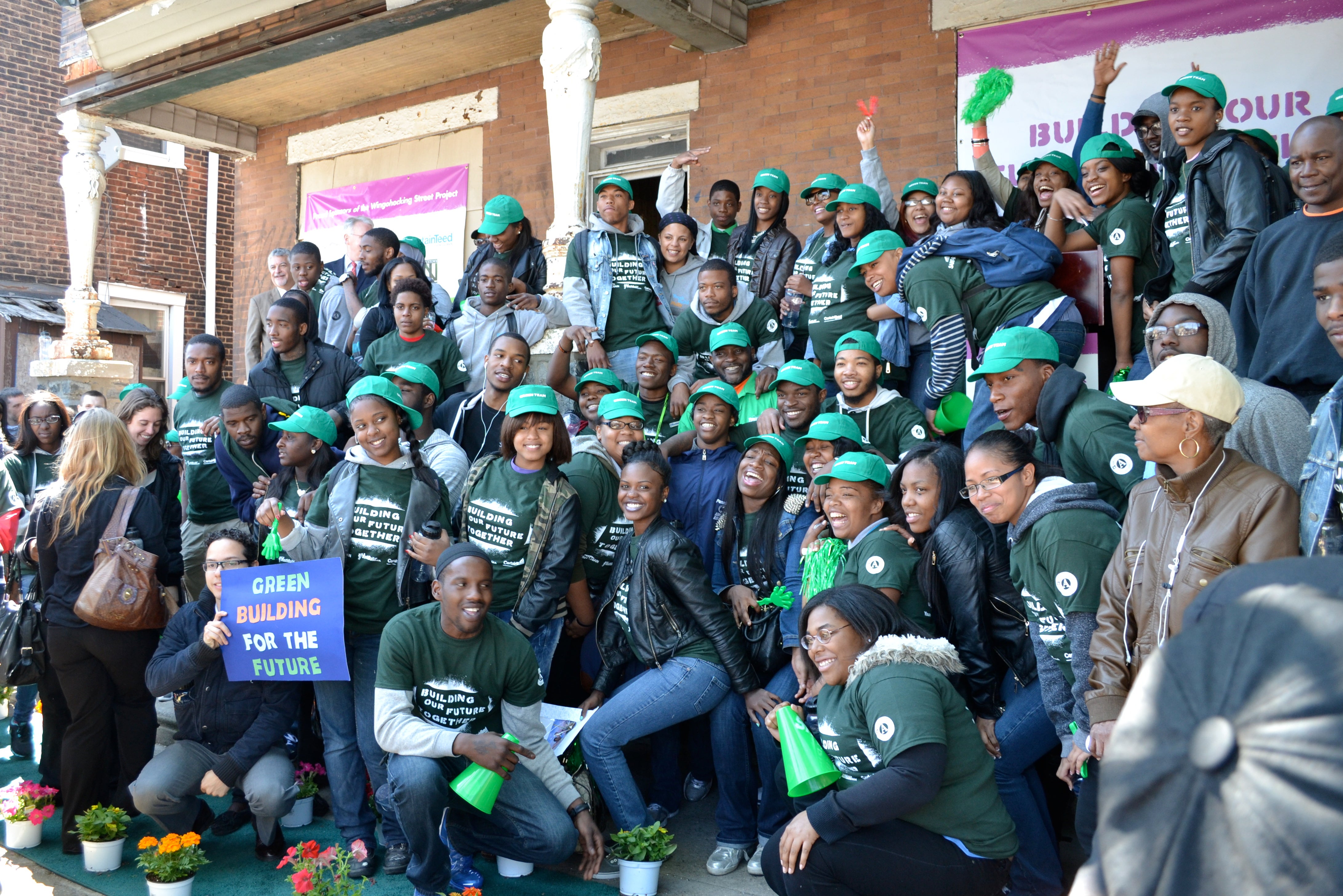 Some of the 120 students who will work on the two homes posed at the groundbreaking ceremony