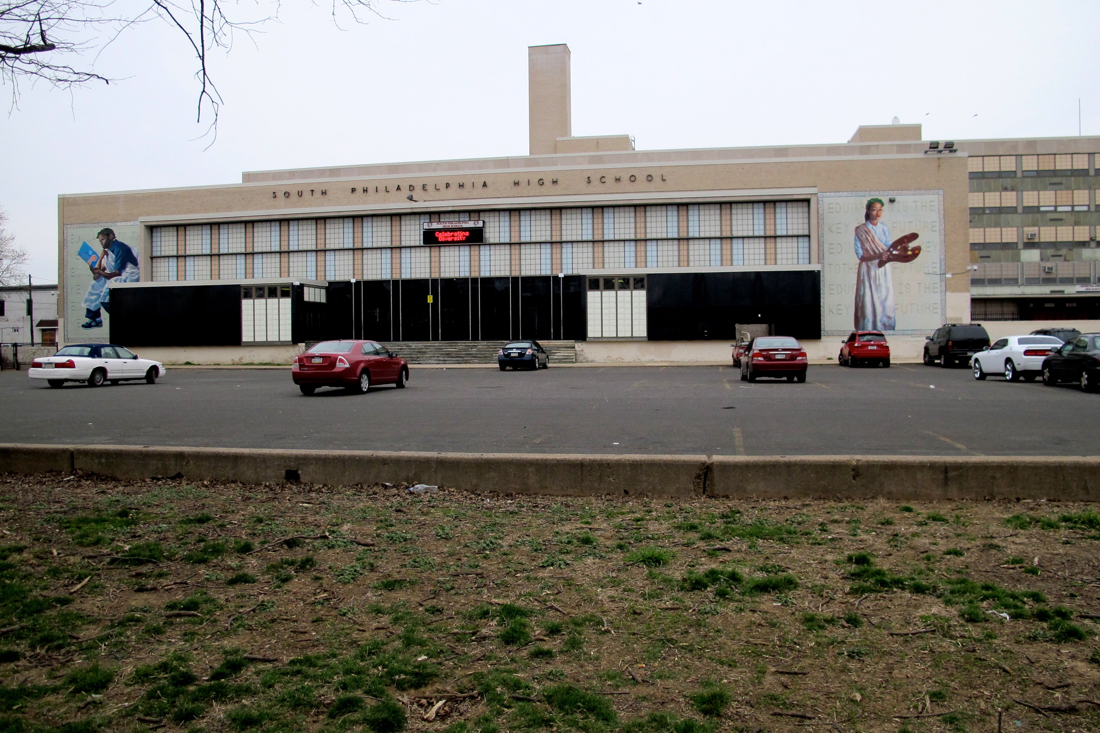 South Philadelphia High School sits in a field of parking with a big planted buffer.