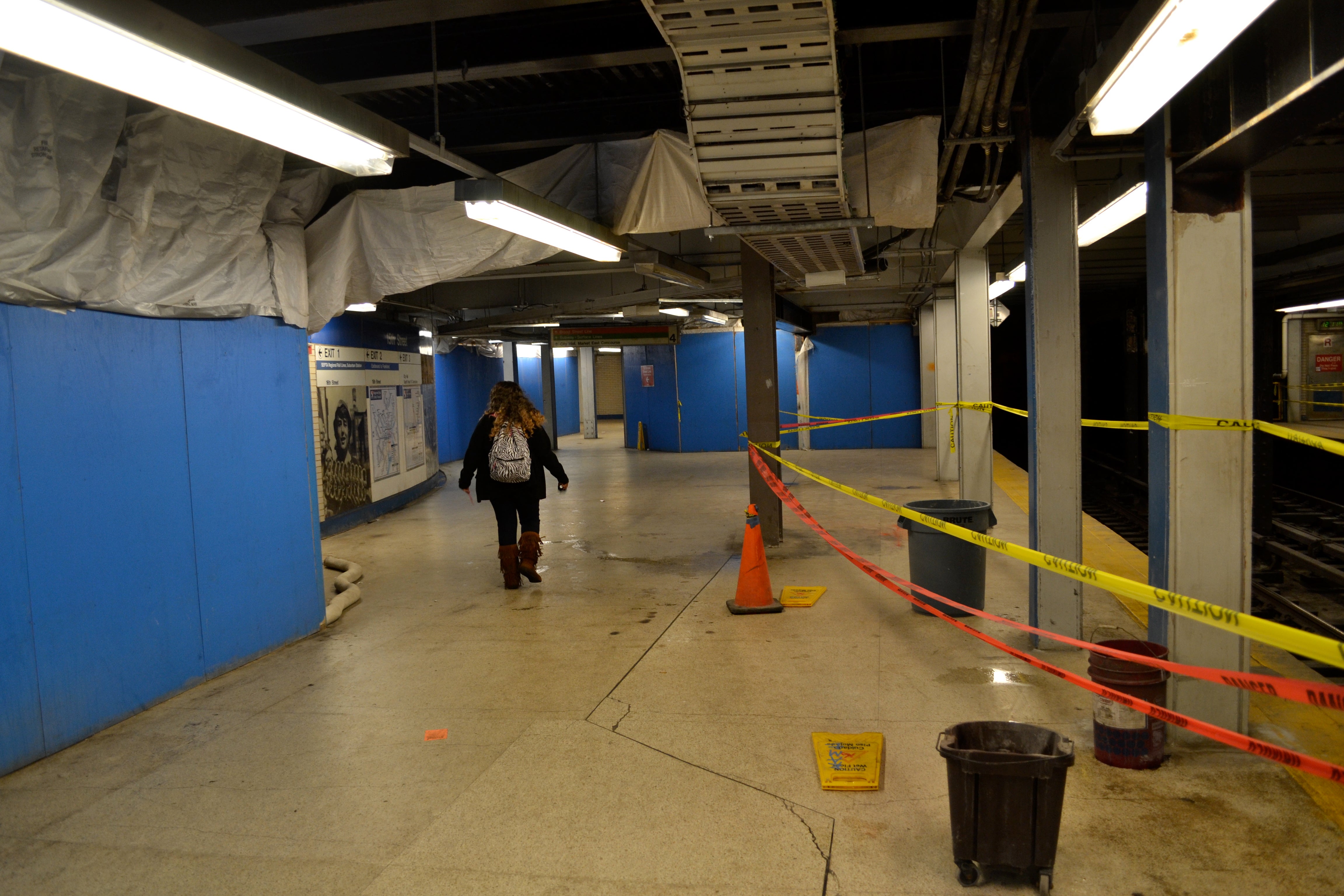 Tarps and buckets catch some of the rain water in 15th Street Station