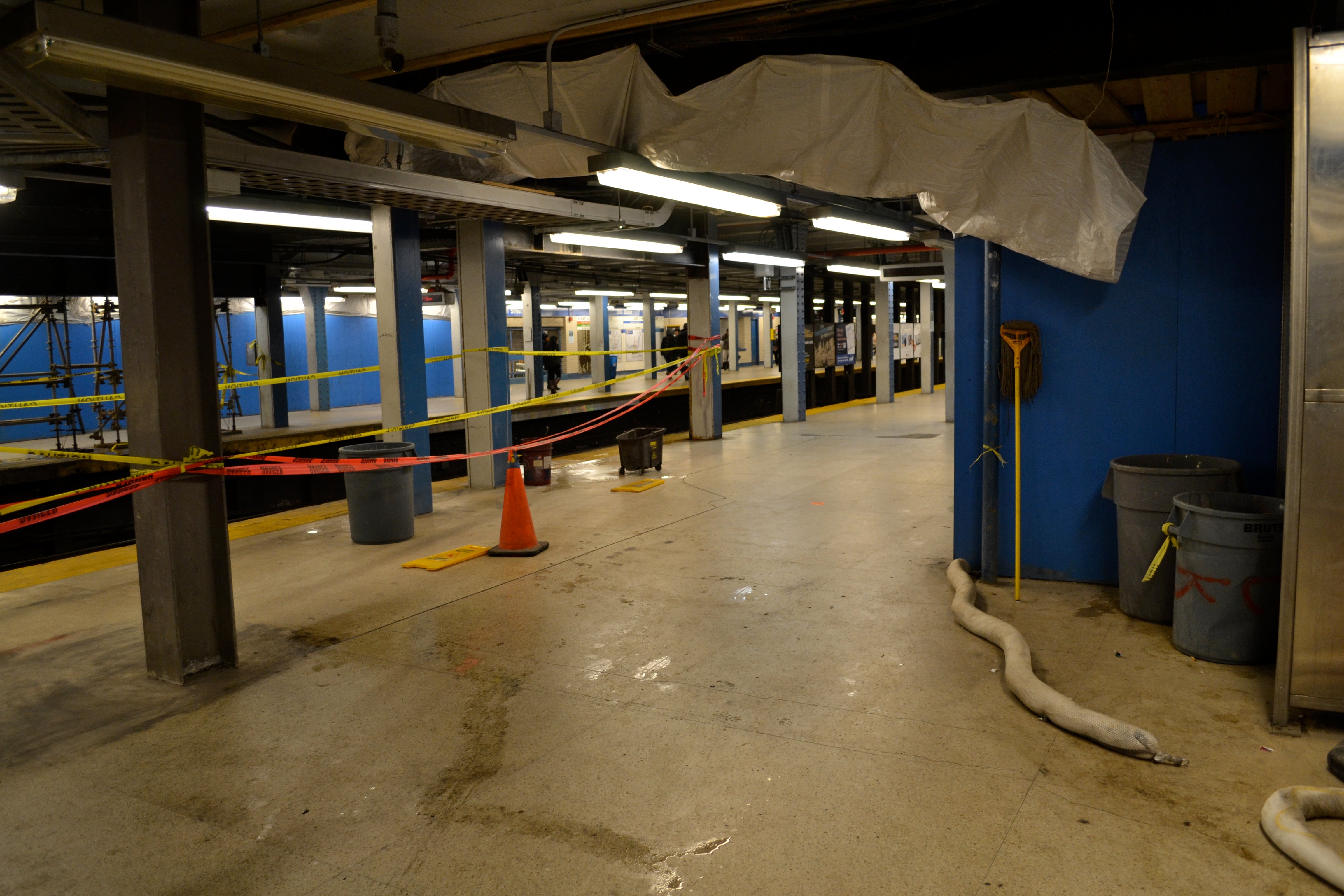 Tarps hung from the portions of the ceiling attempt to collect rain water