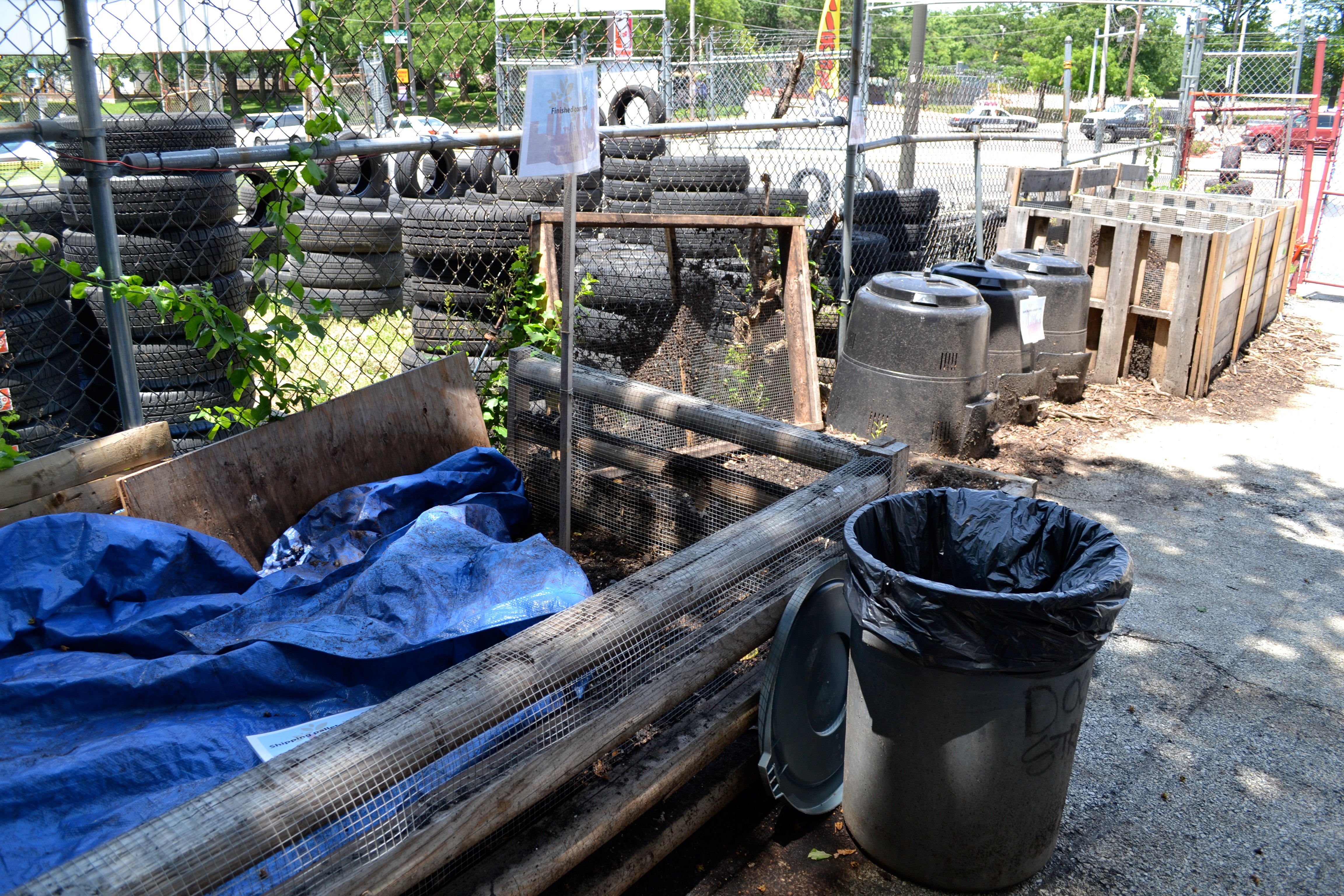 The Dirt Factory's compost contraptions blend in with tires from the neighboring car lot