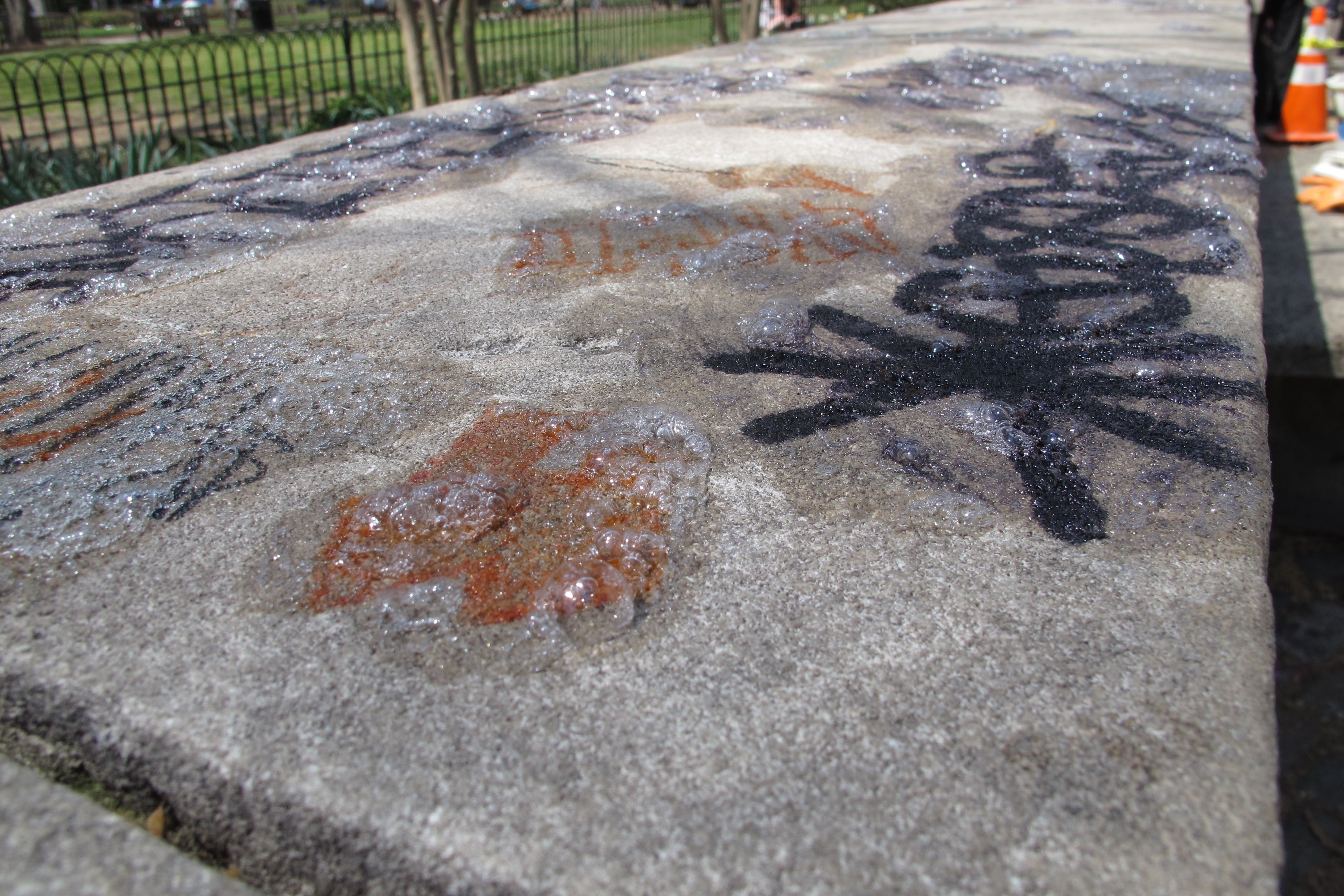 This graffiti in Rittenhouse Square was treated with a solvent prior to power washing.