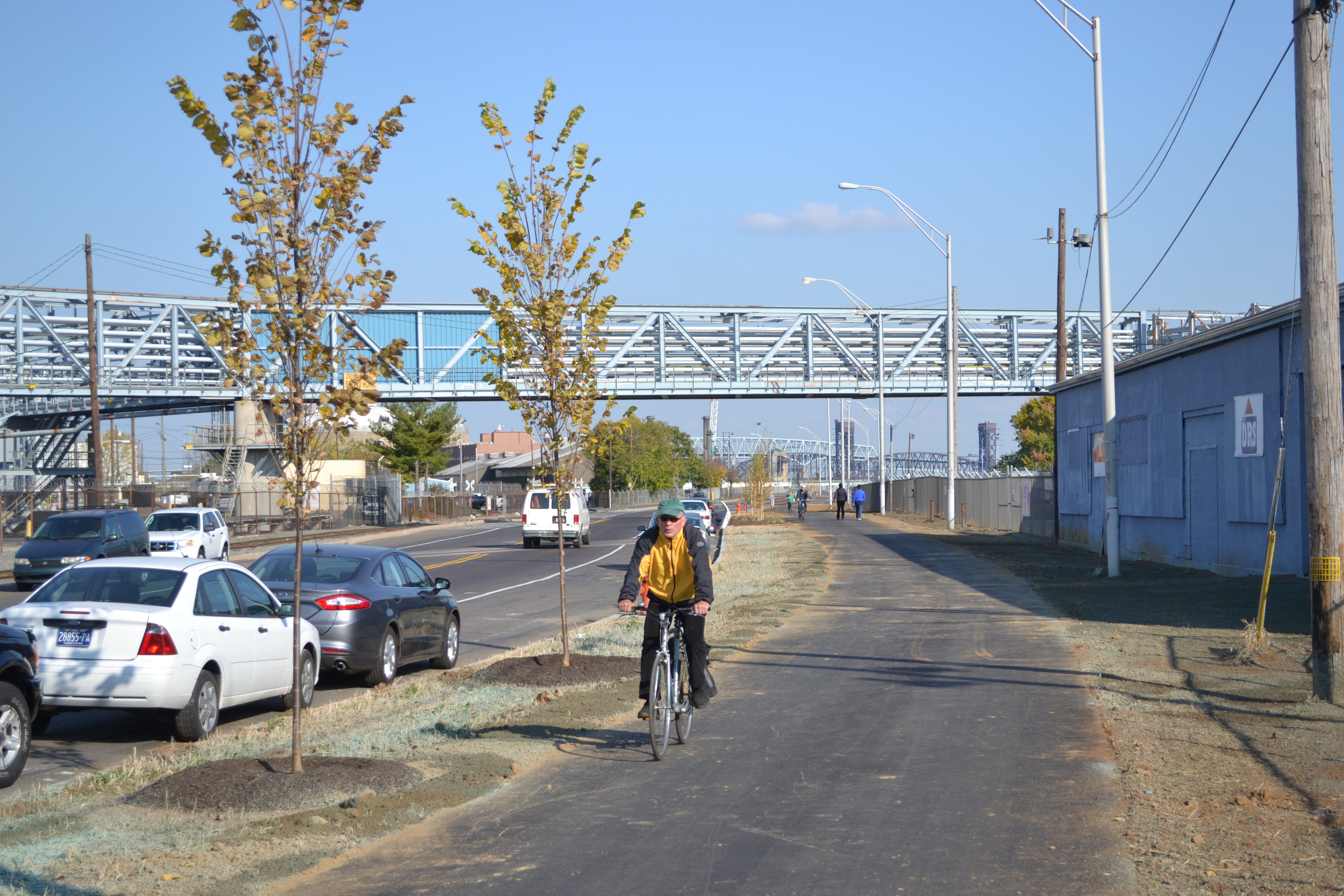 A cyclist cruises on the new Port Richmond Trail's new pervious pavement