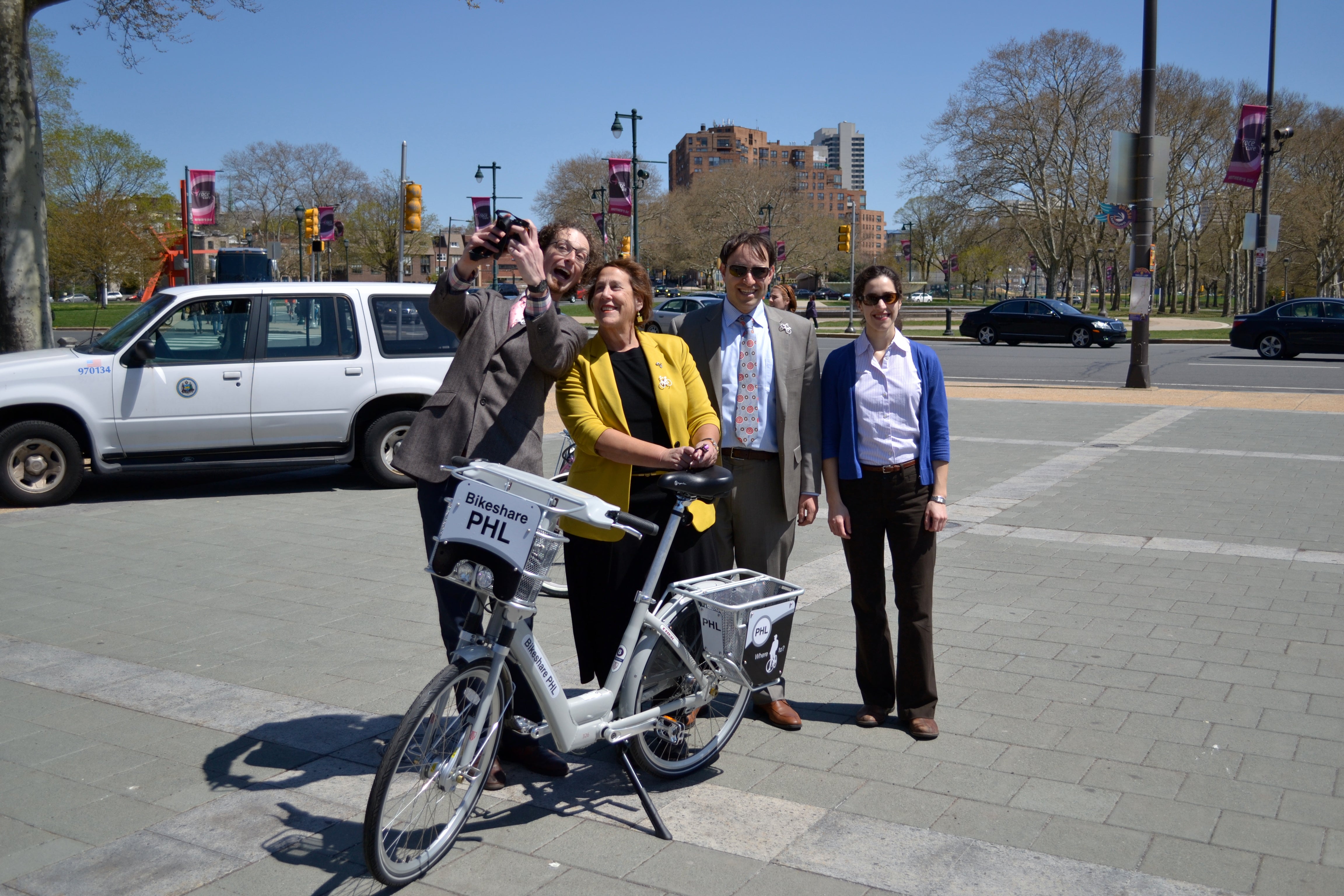 Aaron Ritz and Rina Cutler take a selfie next to the bike share prototype