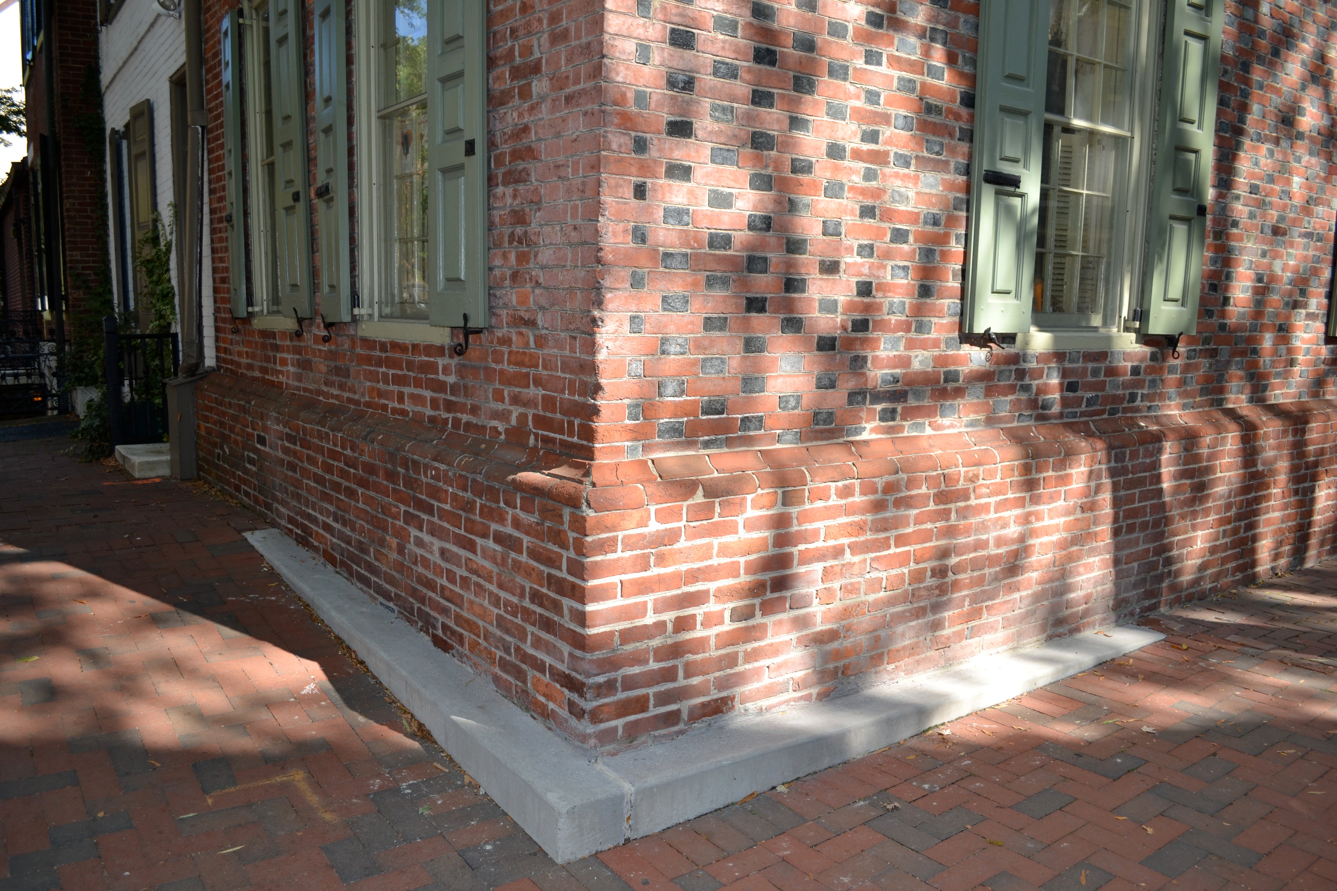 Community members spoke up when the Streets Department installed a concrete cheek wall on a historic, brick home