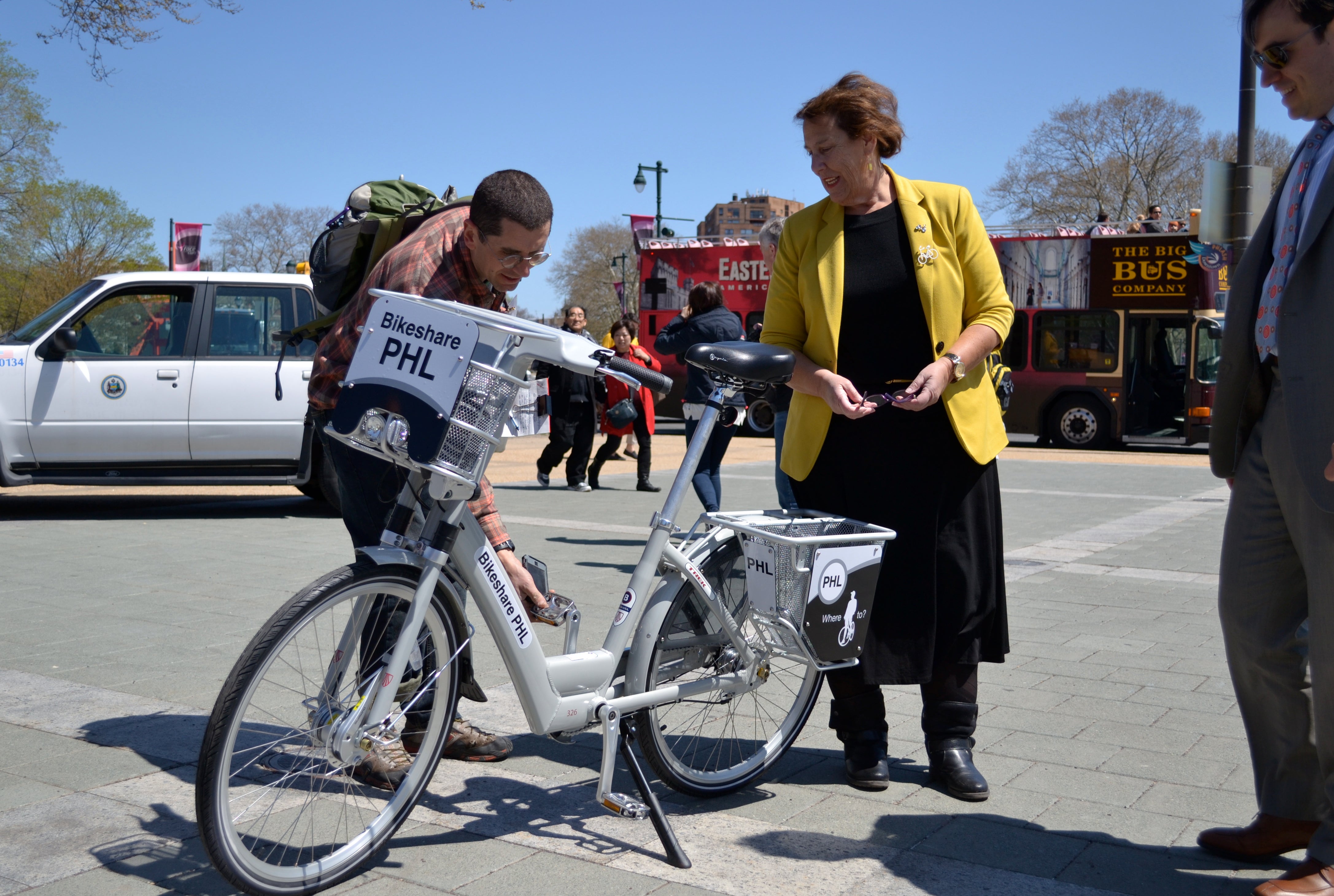 Cutler stands with the model bike-share bike