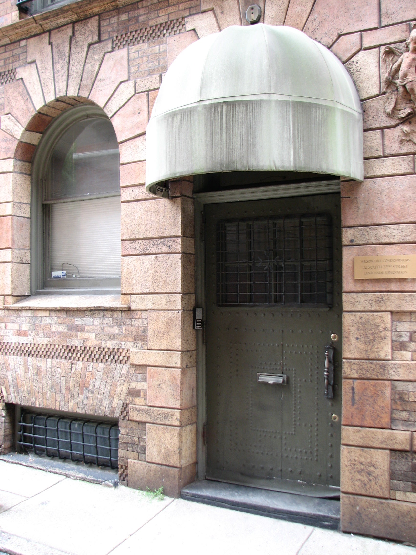 Befitting a men’s clubhouse, the entrance to the former fraternity social hall is off the side street.