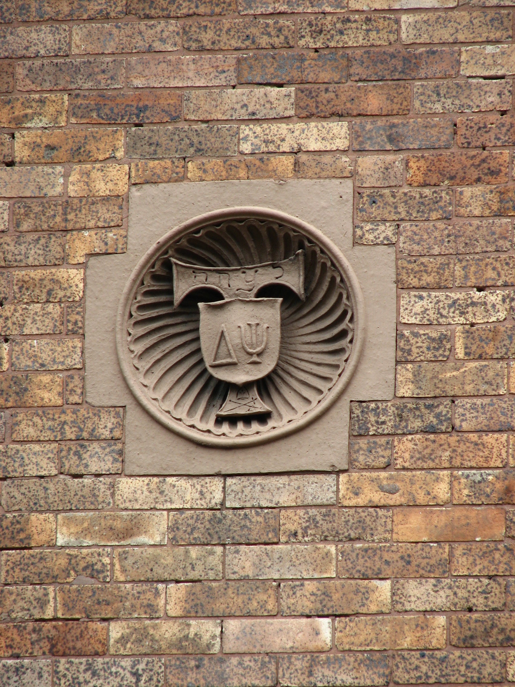 The symbol of the national literary society is carved into the façade.