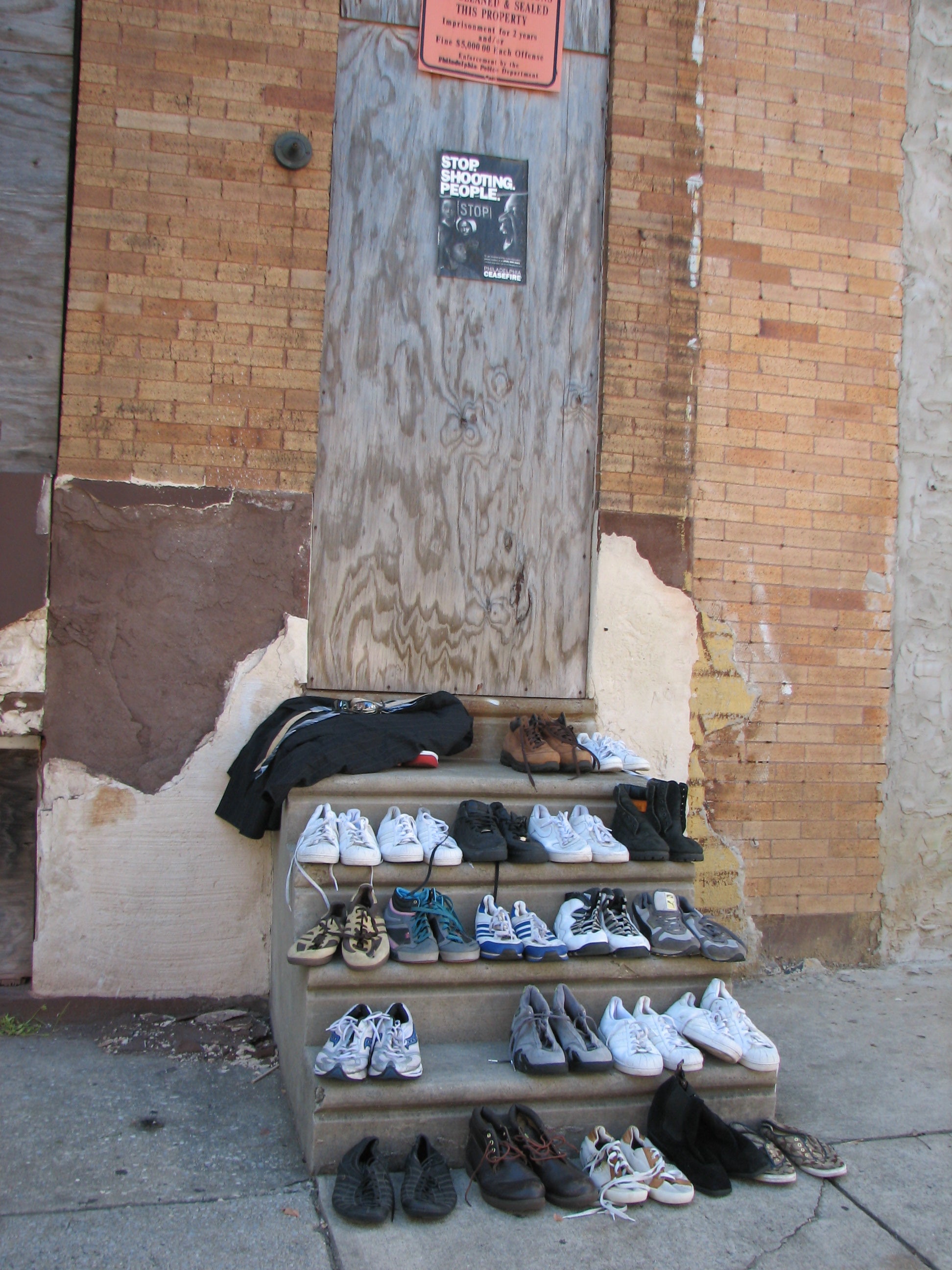 Free sneakers below a sign that says Stop shooting people