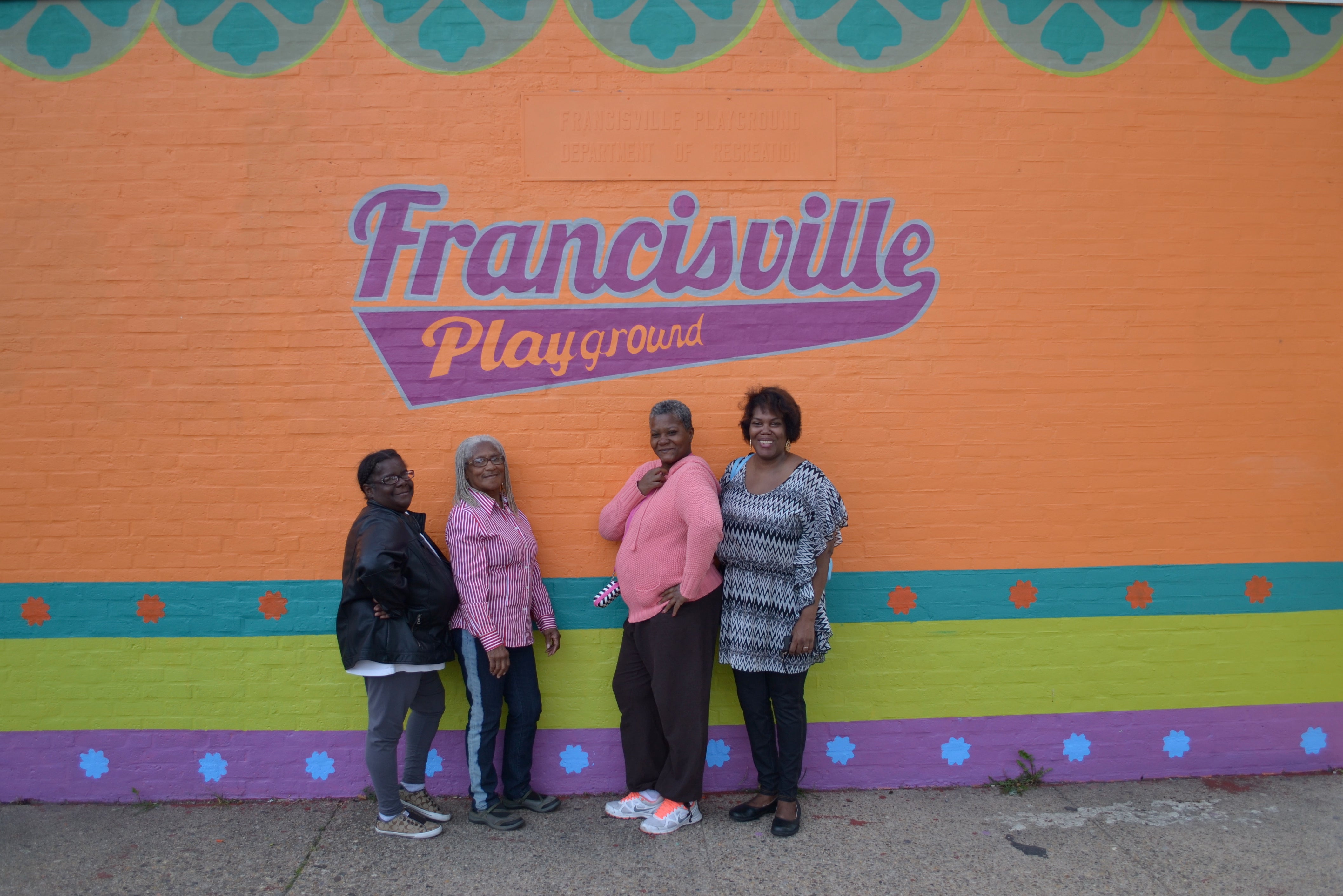 Longtime community members and park-users posed in front of the new mural