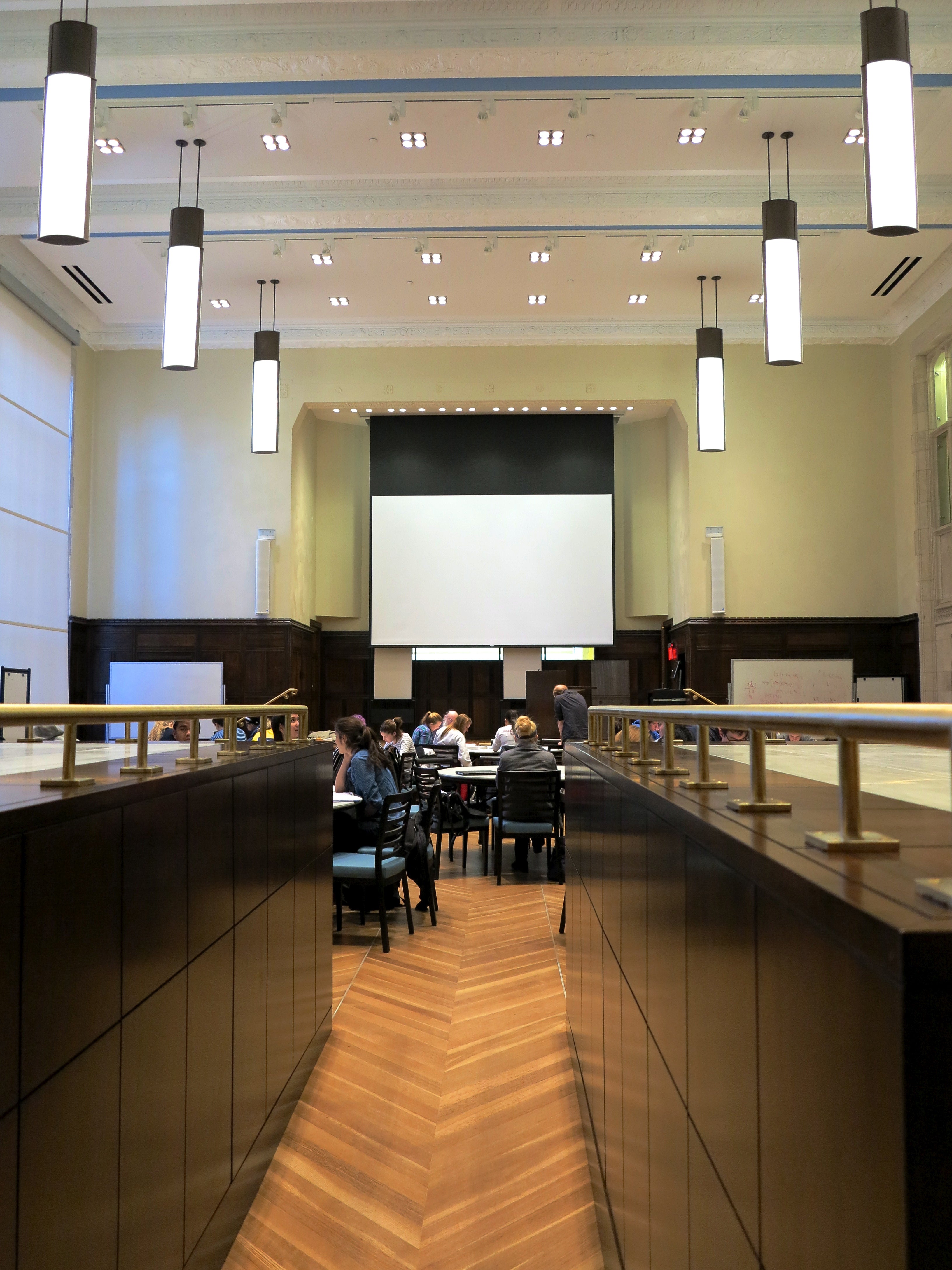 The ARCH auditorium, looking between two wood structures that store alternative seating systems.