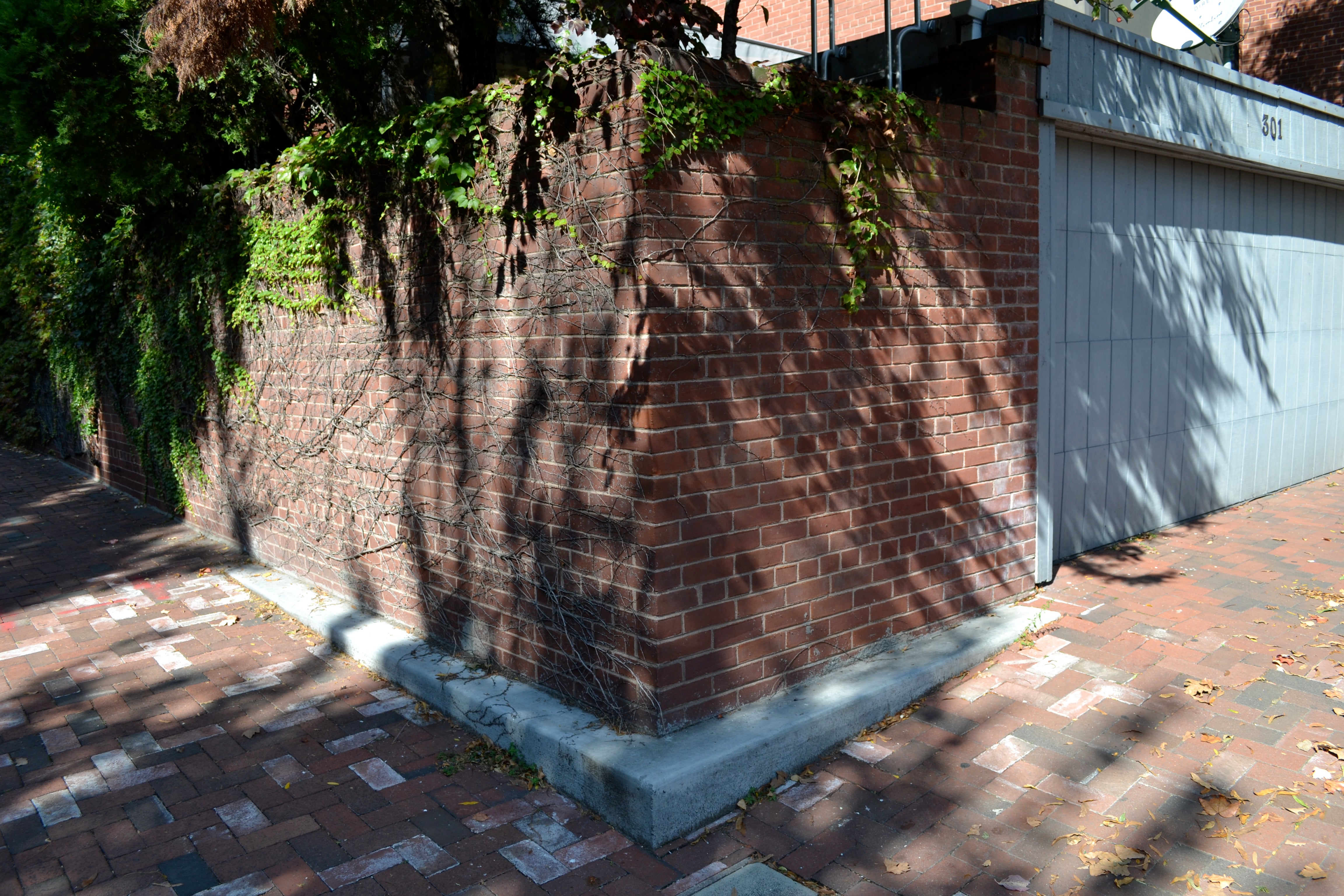 This concrete cheek wall was installed before the Streets Department began matching the cheek wall material to the sidewalk material