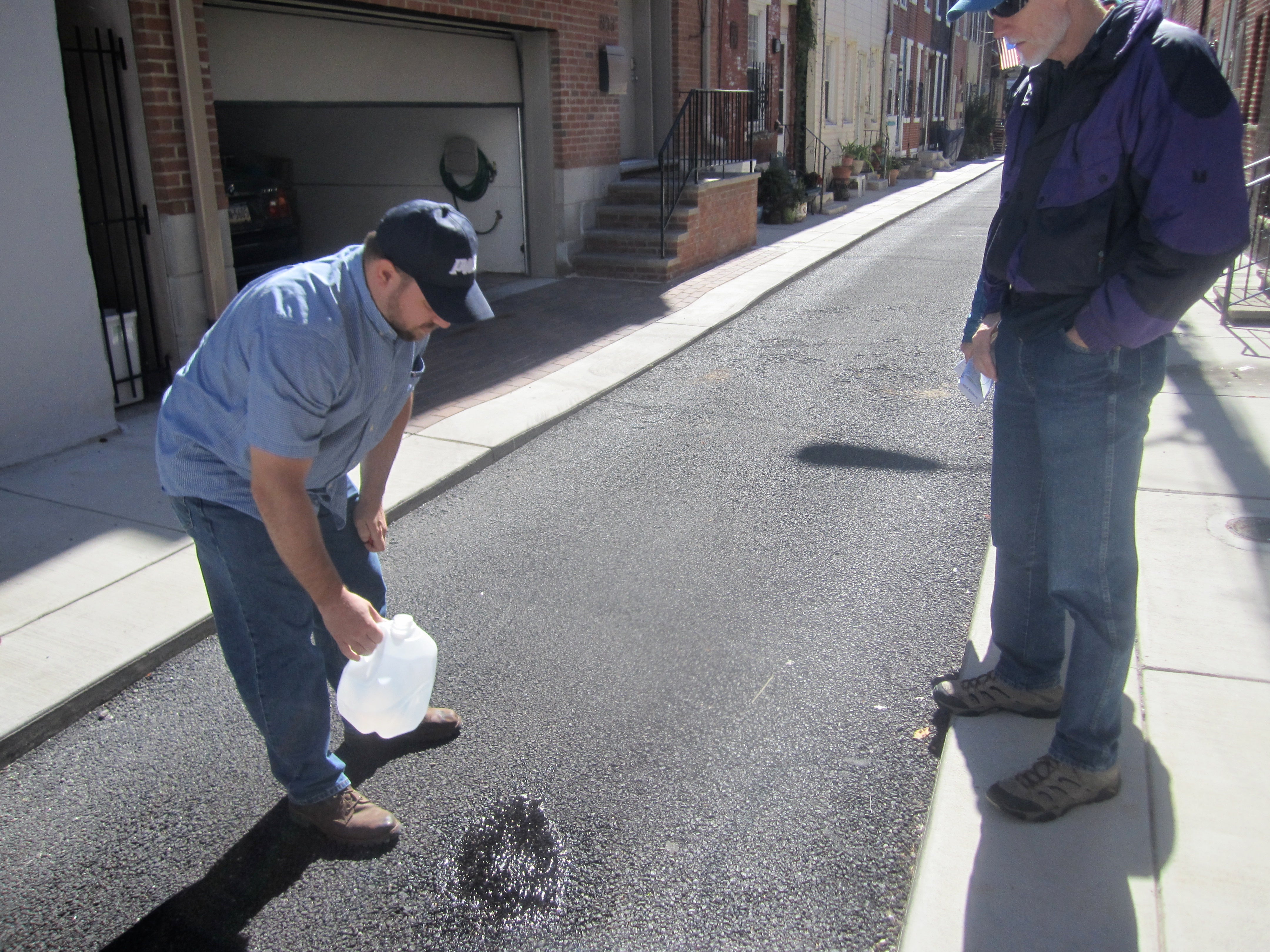 Water poured on Percy Street seeps into the ground almost immediately