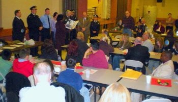 Community Relations officer Mark Mroz received a city citation at the Dec. 15, 2009 Lawncrest Community Association meeting held at St. William's School. Councilwoman Marian Tasco's administra