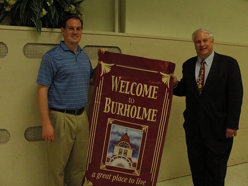 Son and father Matt and Al Taubenberger, board member and president of the Burholme Civic Association respectively, stand with one of 100 Burholme neighborhood signs.