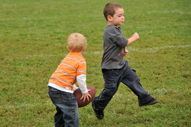 Frankford cousins Anthony Martin, Jr. (l), 2, and Jonathan Martin (r), 3, play their own game of football while watching the Falcons take down the Raiders.