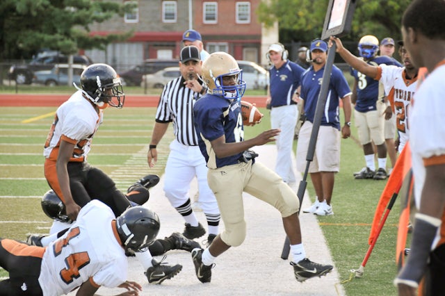 Washington's defensive back Jamear Seals (6) gains several yards on a kickoff return before being forced out of bounds by Overbrook's Andre Sheppard (14), Greg Johnson (23) and James Johnson (