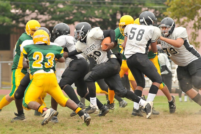 Role reversal, now it's Desmond Strickland (30) on offense, running for several yards while one of his teammates takes the Owls' Tyree Kirkland out of the play. 