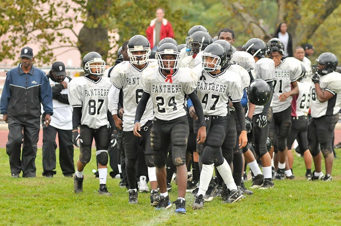 Following their first win of the 2009 season, the Fels Panthers and coaches line up at the 50 yard line and prepare to shake hands with the players and coaches from Edison.