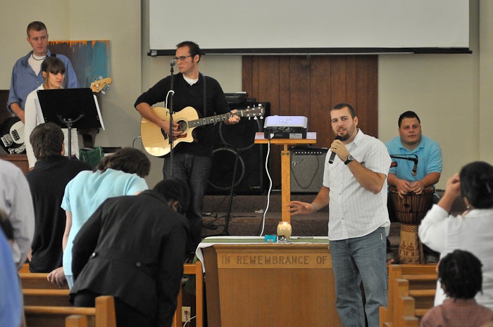 On platform, (L-R) Bob Wykoff, Joy Zerhelt, Associate Pastor Joe Zernhelt and intern Luis Sanchez. Pastor James Rudd is in the foreground standing before the communion table. Photo by Bill Achuff.