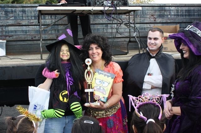 Capt. Deborah Kelly awards the Best Costume to a very happy witch. Photo courtesy of Elsie Stevens.