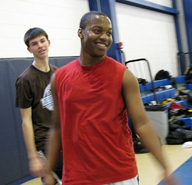 John McCarthy (left, background), 17, and Terrence Bond (foreground), 16, take a break from shooting hoops after school at the Perzel Center. McCarthy is a student at North Catholic High School, and B