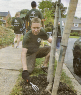 Bill Dobbins of Northeast Tree Tenders cares for a tree the group previously planted, Image courtesy of Rikard Lama for Metro.