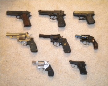 Mike's guns -- Top left to right: Colt Commander Series 80 .45 ACP, Berretta FS-92 9mm pistol, Glock 26 9mm pistol. Middle left to right: Smith & Wesson Model 629 .44 Magnum revolver, Smith & Wes