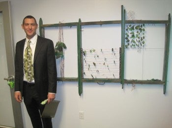 Artist Scott Bickmore and his green art at 3rd Federal Bank's Woodhaven branch. Photo courtesy of 3rd Federal Bank.