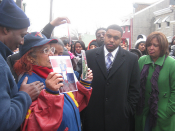 Spence's grandmother Shirley Phelps-Pollard holds up pictures from Spence's Frankford football days.