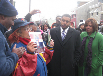 Jason Dawkins and Maria Quinones-Sanchez comfort Chris Spence's family in front of the Frankford bar where he was fatally shot.