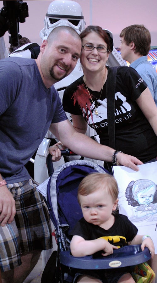 Mayfair's Bob & Danielle Wynne with 18-month-old Logan and his likeness drawn by one of the artists at Comic Con 2011.