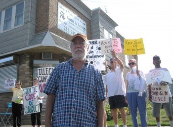 Byran Miller, director of Heeding God's Call, leads a protest at a Fox Chase gun shop.