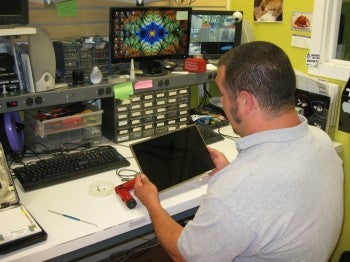 RGB Crew Member Ron Hill working on computer screen.